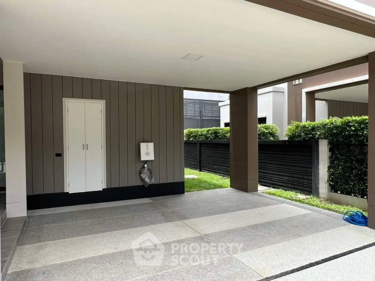 Spacious modern carport with sleek design and lush greenery