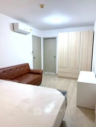 Modern bedroom with sleek furniture and air conditioning in a cozy apartment.