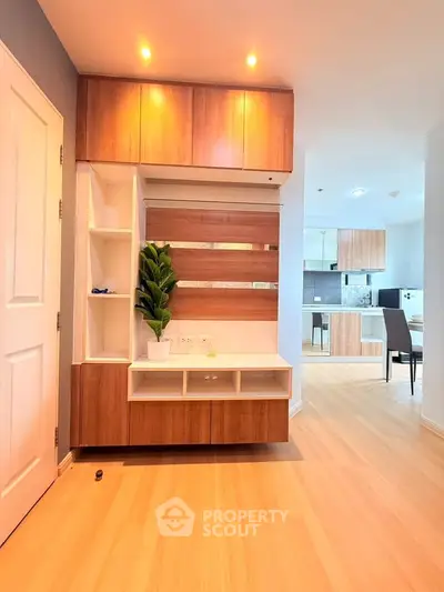 Modern apartment interior with stylish wooden cabinetry and open layout kitchen.