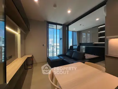 Modern open-plan living room with city view and sleek furniture