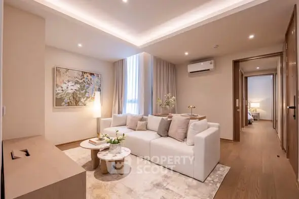 Elegant living room with modern decor, cozy white sofa, and stylish lighting in a contemporary apartment.