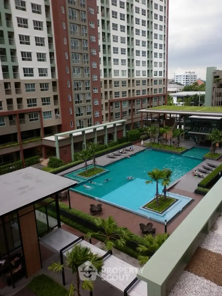 Modern condominium with a stunning pool and lush landscaping, offering a luxurious urban lifestyle.