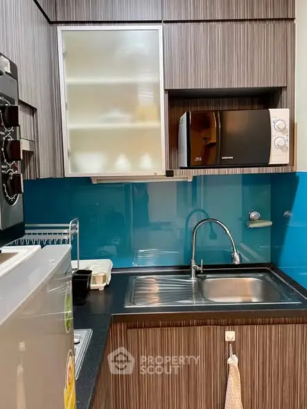Modern compact kitchen with sleek cabinetry and stainless steel sink