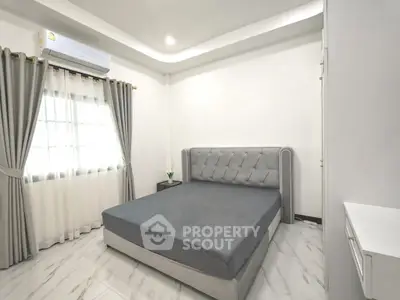 Modern minimalist bedroom with elegant gray bed and stylish curtains