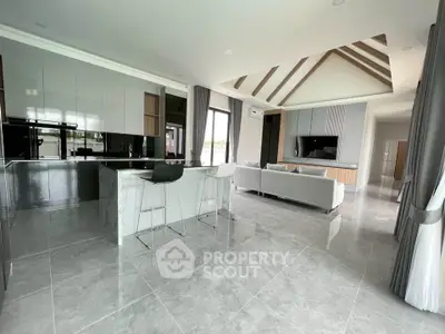 Spacious modern living room with open kitchen and sleek design