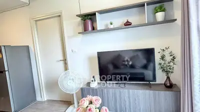 Modern living room with stylish decor and flat-screen TV, perfect for cozy relaxation.