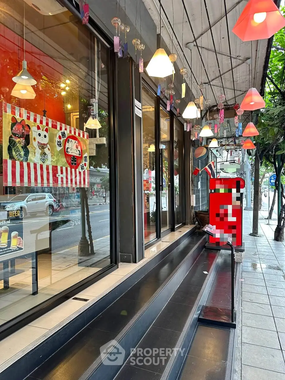 Charming storefront with vibrant decor and inviting entrance on bustling street.