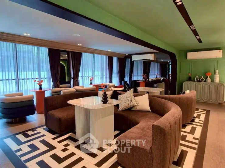 Luxurious modern living room with stylish furniture and large windows