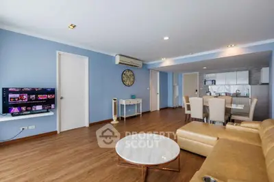 Spacious living room with modern decor and open kitchen layout