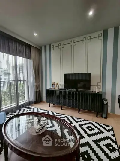 Modern living room with stylish decor and city view from large window.