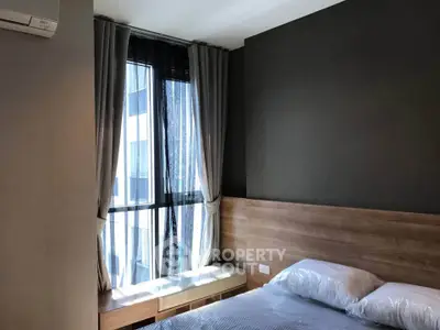 Modern bedroom with large window and stylish decor in urban apartment