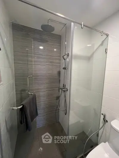Modern bathroom with glass shower enclosure and sleek tile design