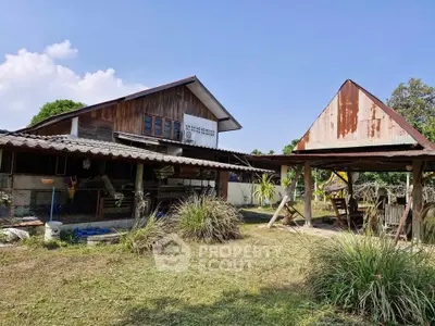 Charming rustic house with wooden facade and spacious outdoor area, perfect for countryside living.