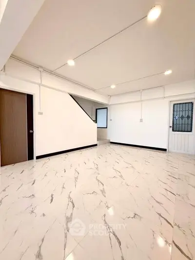 Spacious modern living room with marble flooring and bright lighting