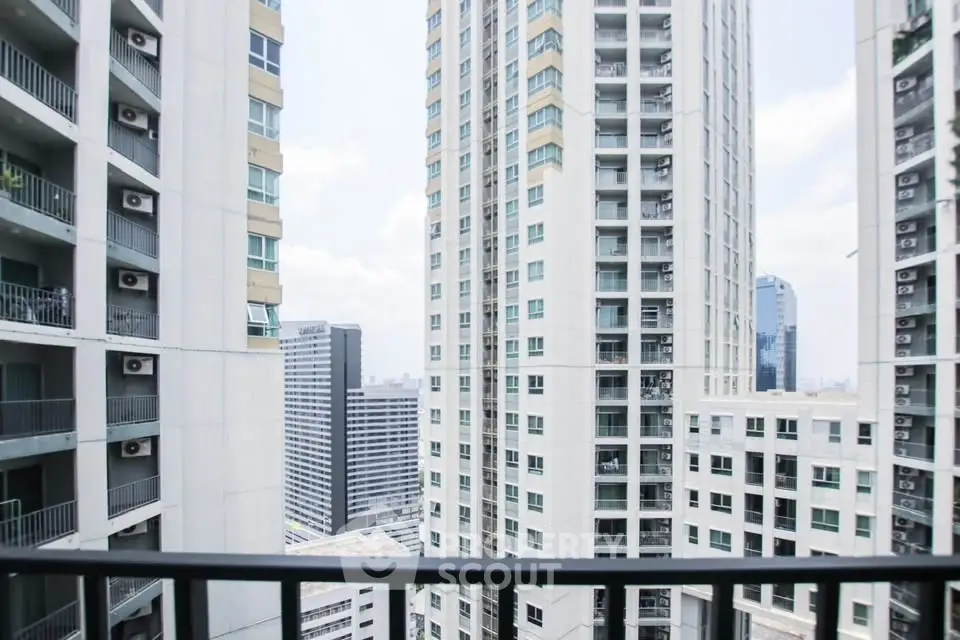 Stunning high-rise cityscape view from a modern apartment balcony, showcasing urban living at its finest.