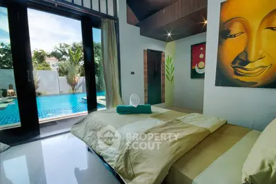 Luxurious bedroom with pool view and artistic decor in tropical villa