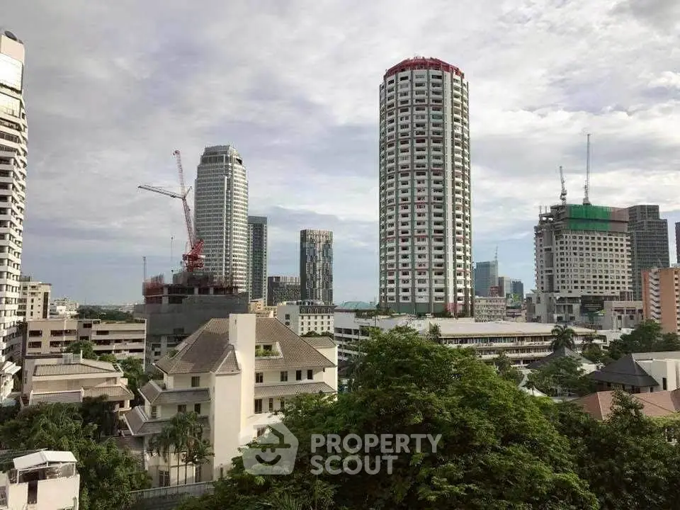 Stunning cityscape view with modern high-rise buildings and lush greenery.