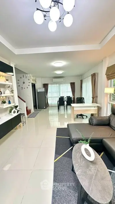 Spacious modern living room with elegant decor and ample natural light.