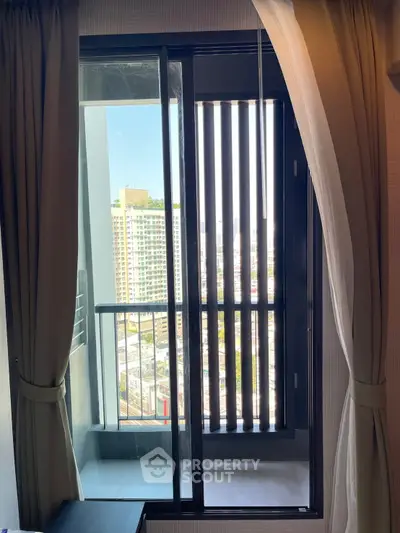 Modern apartment balcony with city view and sliding glass door