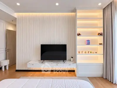 Modern living room with sleek TV setup and illuminated shelving, showcasing elegant interior design.