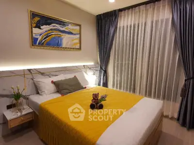 Cozy bedroom with modern decor, featuring a plush bed and elegant curtains.