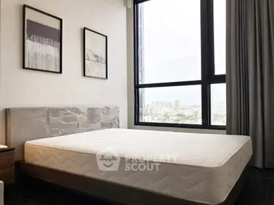 Modern bedroom with large window offering stunning city views, featuring a minimalist design and elegant decor.