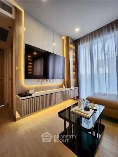 Modern living room with sleek design, large TV, and floor-to-ceiling windows for natural light.