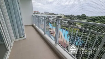 Spacious balcony with pool view in modern apartment complex