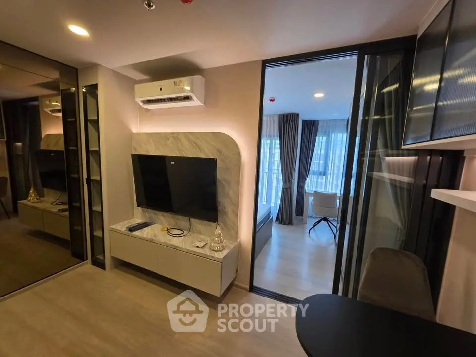 Modern living room with sleek design and large windows in a stylish apartment.