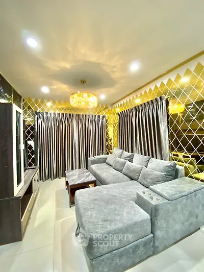 Luxurious living room with plush gray sofa and elegant gold accents