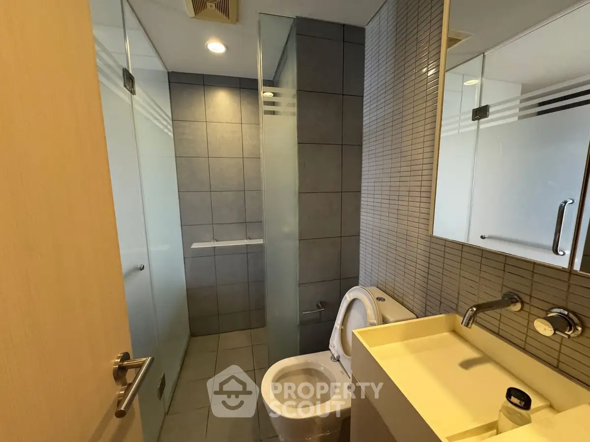 Modern bathroom with sleek fixtures and glass shower enclosure