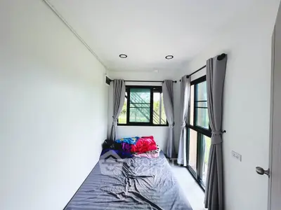 Bright bedroom with large windows and modern decor, perfect for natural light lovers.