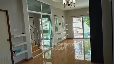 Spacious modern living area with glossy tile flooring and large windows