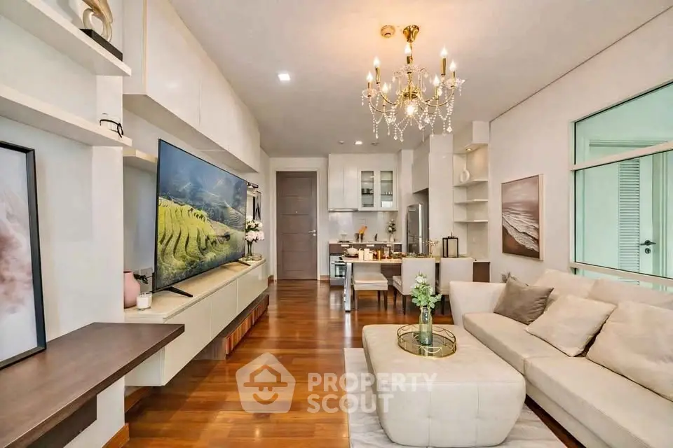 Luxurious living room with elegant chandelier and modern open kitchen layout