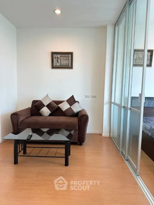Cozy living room with brown sofa and glass coffee table, modern decor