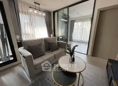 Modern living room with elegant decor and natural light, featuring a cozy sofa and stylish coffee table.
