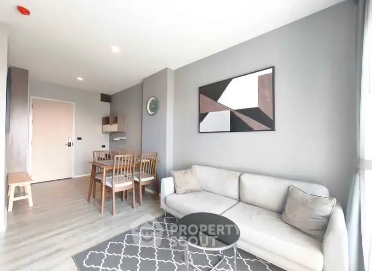 Modern living room with stylish decor and dining area in open layout apartment.