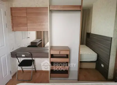 Modern bedroom with built-in wardrobe and study desk, featuring sleek wooden finishes and a cozy bed setup.