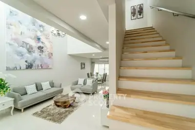 Spacious modern living room with elegant staircase and stylish decor