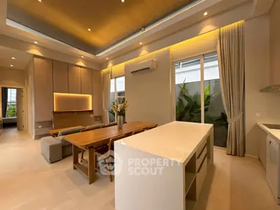 Luxurious open-plan living room with modern kitchen and elegant dining area, featuring high ceilings and ambient lighting.
