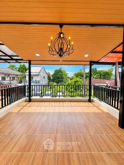 Spacious balcony with elegant chandelier and scenic neighborhood view