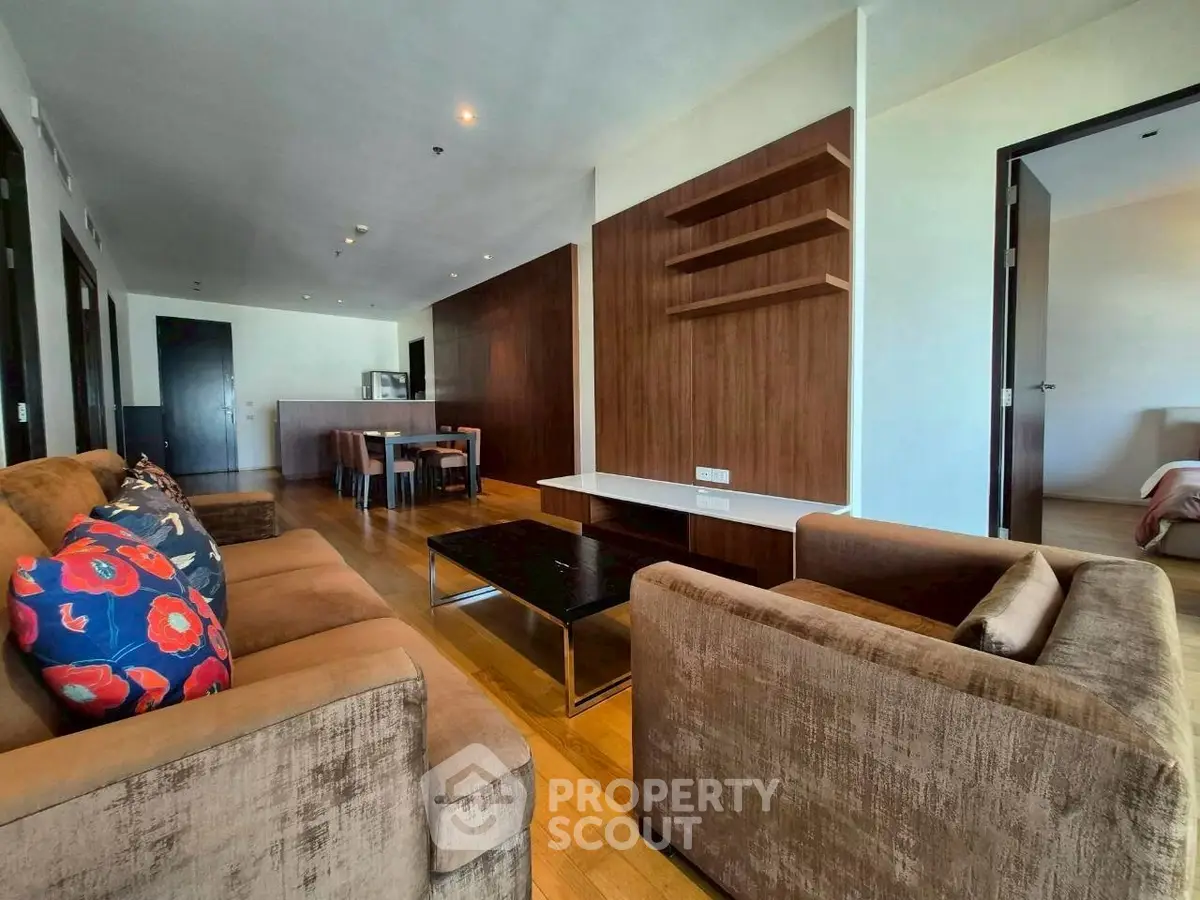 Spacious modern living room with elegant furniture and open kitchen layout