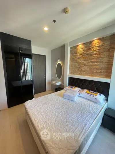 Modern bedroom with stylish brick accent wall and cozy lighting
