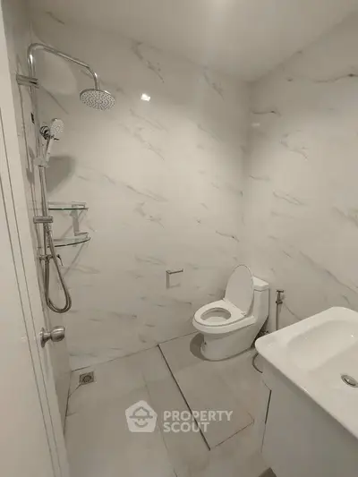 Modern bathroom with marble walls and sleek fixtures in a contemporary home.