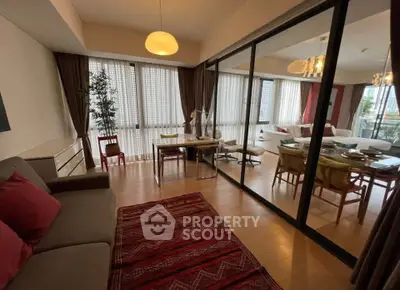 Spacious living room with elegant decor and large windows in a modern apartment.