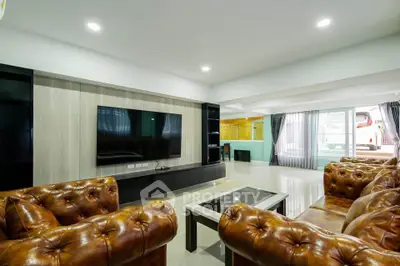 Luxurious living room with leather sofas and modern entertainment center