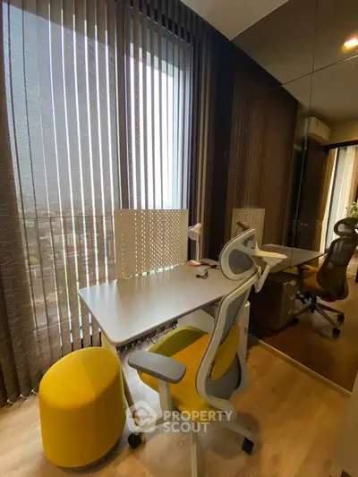 Modern study room with sleek desk and ergonomic chair, featuring floor-to-ceiling windows and stylish decor.