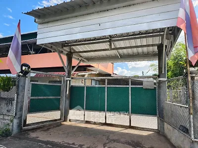 Charming gated entrance with traditional flags and metal fencing, perfect for secure and private living.