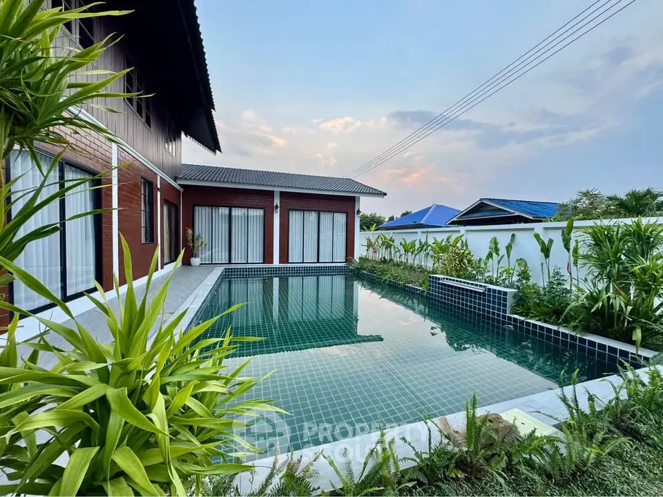 Stunning modern home with a luxurious private pool and lush greenery, perfect for relaxation and entertainment.