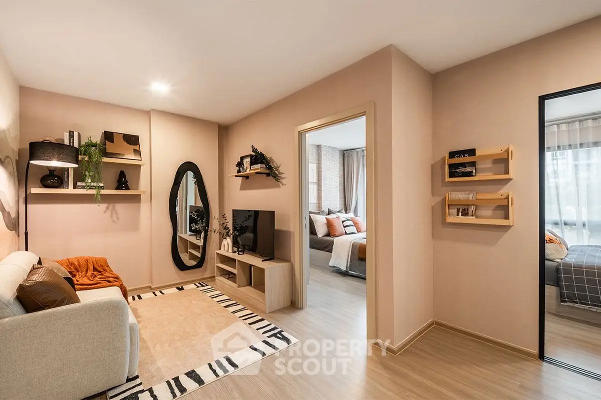 Modern living room with stylish decor and cozy ambiance, leading to a chic bedroom.